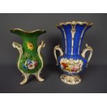 Two early 20th century twin handled vases, each with hand painted floral decoration,