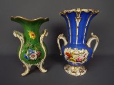 Two early 20th century twin handled vases, each with hand painted floral decoration,