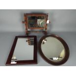 A mahogany framed toilet mirror and two wall mirrors.