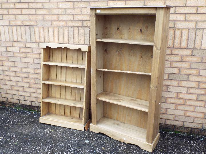 Two pine, freestanding bookcases, largest approximately 150 cm x 84 cm x 30 cm.