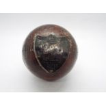 An antique cricket ball with silver presentation shield M.F.C.C.C J Sayle Hat Trick Aug 12th 1911.