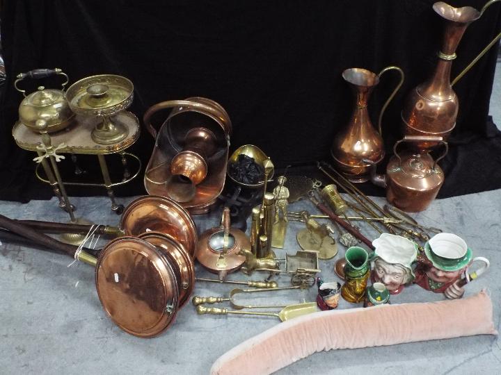 A large collection of copper and brass ware to include teapot, ewers / jugs, ornaments and similar,