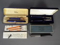 A vintage Parker Duofold pen and pencil set, a further Parker fountain pen and two others.