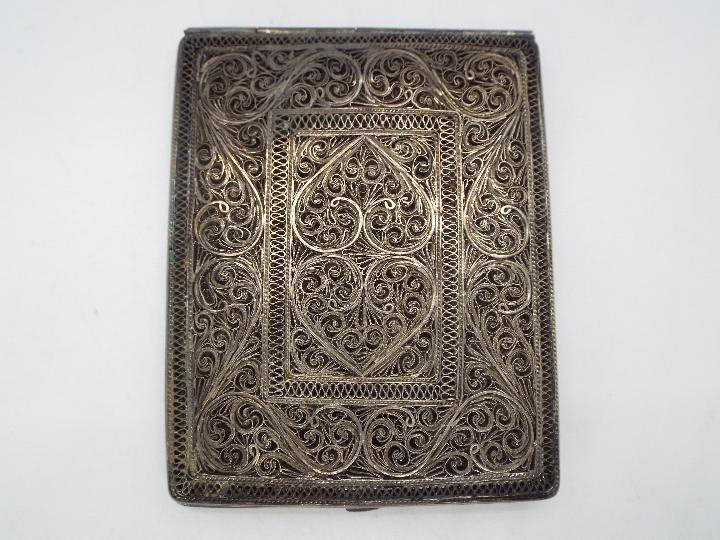 An attractive, white metal, filigree cigarette case 9.5 cm x 7.5 cm, 138 grams all in.