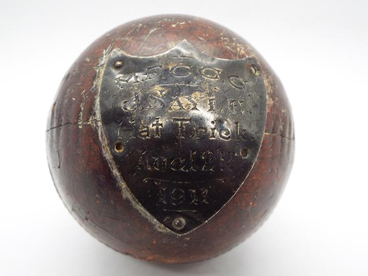 An antique cricket ball with silver presentation shield M.F.C.C.C J Sayle Hat Trick Aug 12th 1911. - Image 2 of 3