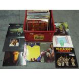 A box of 12" vinyl records to include Dr Hook, Peter Frampton, Genesis, Beach Boys, Bryan Adams,