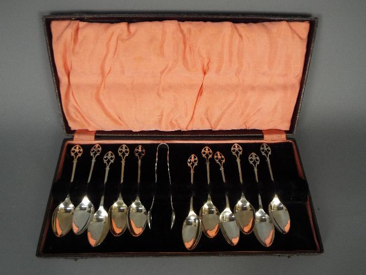 A cased set of George V hallmarked silver coffee spoons and sugar tongs (one spoon lacking),