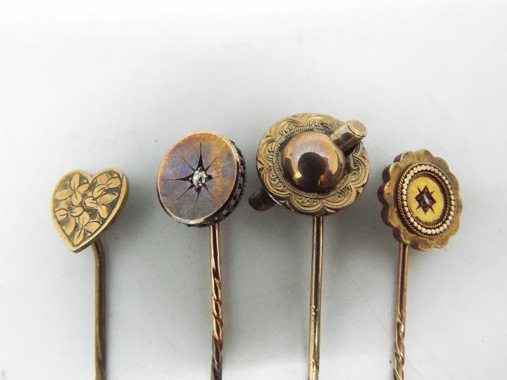 Four yellow metal stick pins, two of which are stone set, each contained in a case. - Image 2 of 3