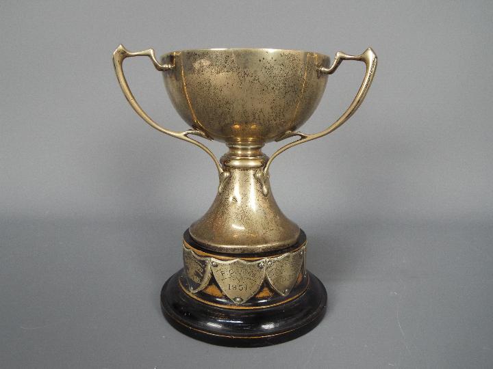 A George V hallmarked silver, Art Nouveau style, triple handled trophy, Sheffield assay 1933,