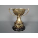 A George V hallmarked silver, Art Nouveau style, triple handled trophy, Sheffield assay 1933,