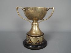 A George V hallmarked silver, Art Nouveau style, triple handled trophy, Sheffield assay 1933,