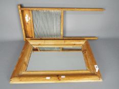 A pine framed wall mirror, 62 cm x 42 cm and a pine washboard.
