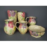 A quantity of Art Deco, Arthur Wood, ceramics with floral decoration and silvered rims,