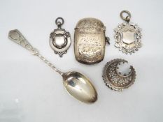 A collection of hallmarked silver items to include vesta case, spoon, fobs and a brooch,