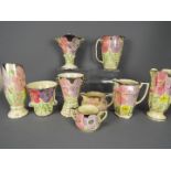 A collection of Art Deco ceramics with floral decoration by Arthur Wood,