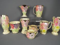 A collection of Art Deco ceramics with floral decoration by Arthur Wood,