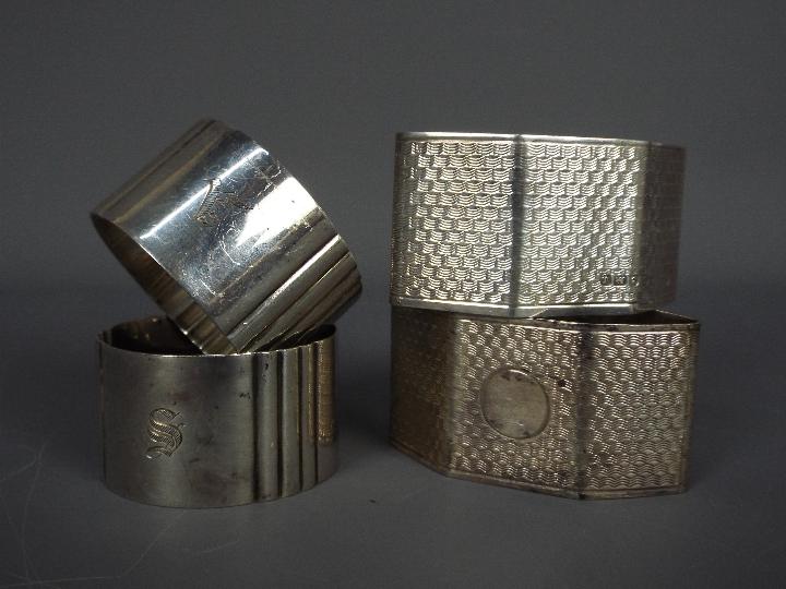 Four hallmarked silver napkin rings,