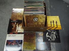 A collection of 12" vinyl records to include Alice Cooper, The Spencer Davis Group, Cher,