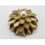 A 9ct gold and pearl 'Flowerhead' pendant / brooch, approximately 8.8 grams all in.