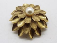 A 9ct gold and pearl 'Flowerhead' pendant / brooch, approximately 8.8 grams all in.