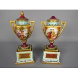 A pair of late 19th or early 20th century Vienna style, porcelain urns and covers,