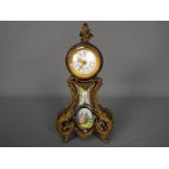 A Sevres style porcelain cased desk clock with metal mounts,