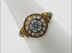 A 15ct gold ring set with seed pearls and black enamel, size N½, approximately 2.6 grams all in.