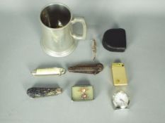 A mixed lot of collectables to include pen knives, vintage cigarette lighter,