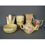 A quantity of Arthur Wood, Art Deco ceramics with floral decoration,