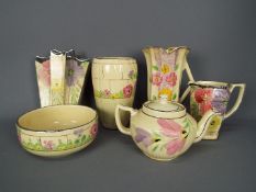 A quantity of Arthur Wood, Art Deco ceramics with floral decoration,