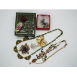 A collection of costume jewellery, necklaces, brooches, earrings.