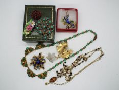 A collection of costume jewellery, necklaces, brooches, earrings.