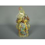 A Murano glass figure depicting a lady holding a fan,