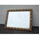 A large bevel edge wall mirror with black and gold coloured frame, approximately 83 cm x 110 cm.