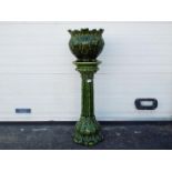 A green glazed, Art Nouveau style jardiniere and stand, approximately 95 cm (h).