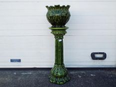 A green glazed, Art Nouveau style jardiniere and stand, approximately 95 cm (h).