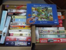 A large quantity of jigsaw puzzles, two boxes.