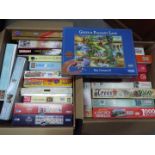 A large quantity of jigsaw puzzles, two boxes.