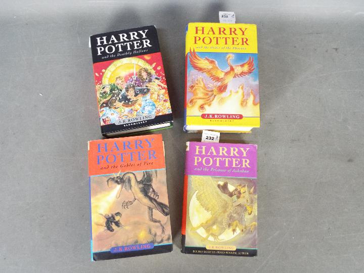Four hardback Harry Potter books, all with dust jackets,