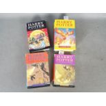 Four hardback Harry Potter books, all with dust jackets,