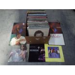A box containing in excess of 120 12" vinyl records to include Bros, The Communards, Peter Frampton,