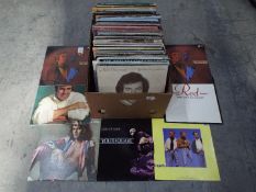 A box containing in excess of 120 12" vinyl records to include Bros, The Communards, Peter Frampton,