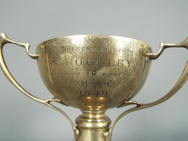 A George V hallmarked silver, Art Nouveau style, triple handled trophy, Sheffield assay 1933, - Image 5 of 6