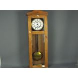 A pine cased wall clock, approximately 90 cm x 31 cm.