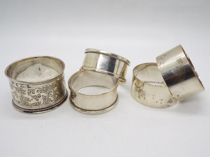 Five hallmarked silver napkin rings, varying assay and date marks, approximately 98 grams / 3.