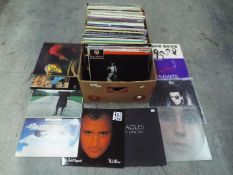 A large box of 12" vinyl records to include Gary Numan, Dead Or Alive, Cher, The Eagles,