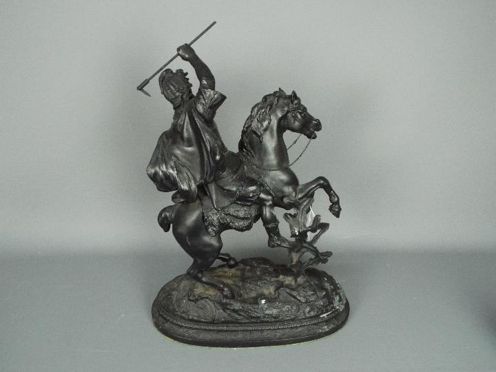 A cast metal sculpture depicting a warrior on horseback, approximately 53 cm (h). - Image 4 of 4