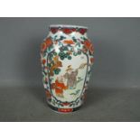 A large Chinese vase decorated with two panels of figures with foliate and floral scrolls between,