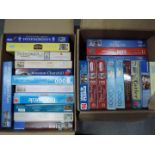 A large quantity of jigsaw puzzles, two boxes.