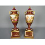 A pair of Vienna style, porcelain urns and covers,